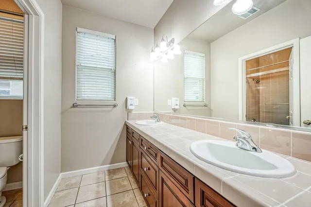 a bathroom with a sink a vanity and a mirror