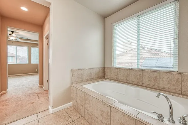 a spacious bathroom with a bathtub and a shower