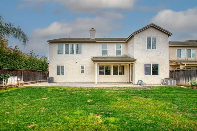 a front view of house with a garden