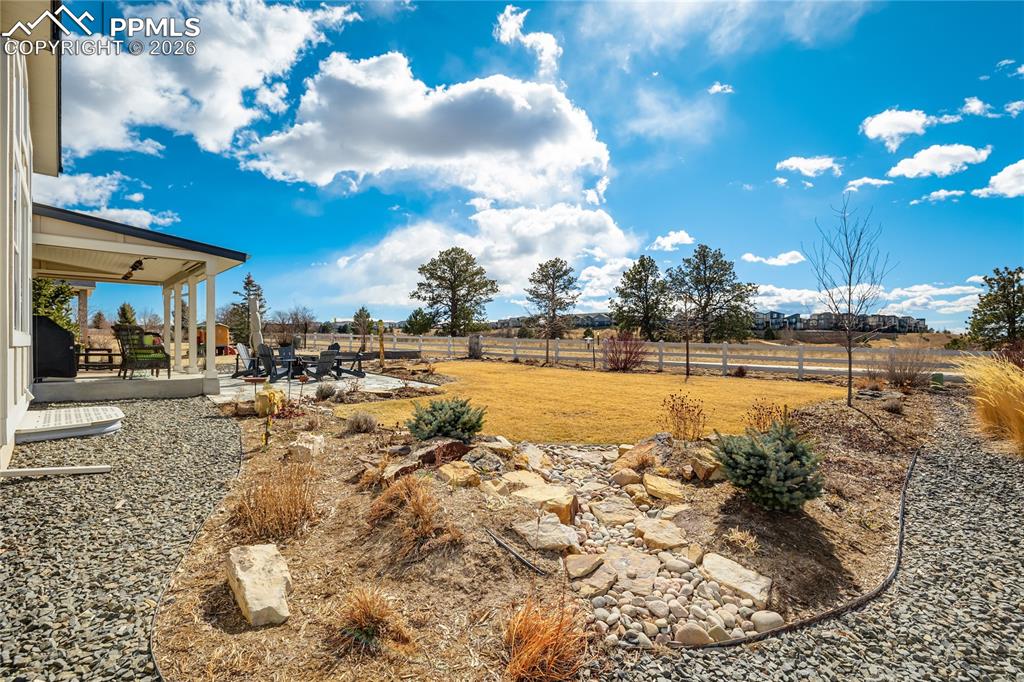 1265 Foothills Farm Way Colorado Springs, CO 80921 - Photo 42 of 50 a view of a swimming pool with an outdoor seating and a yard