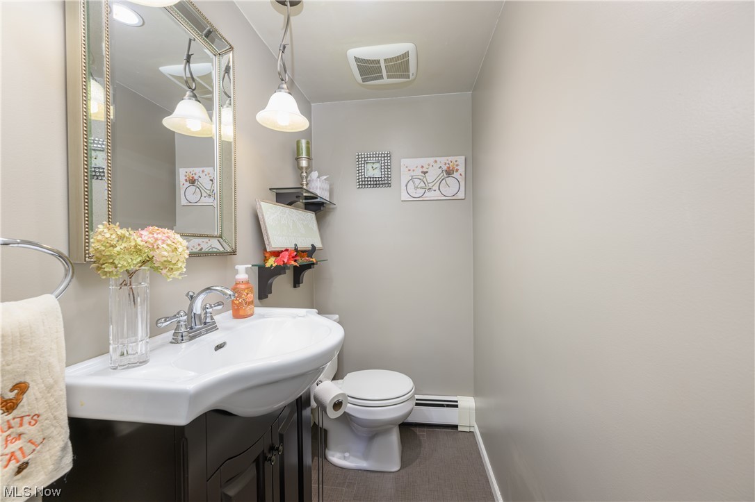 5304 Sibila Road Northwest Canton, OH 44718 - Photo 13 of 29 Bathroom with baseboard heating, toilet, and large vanity