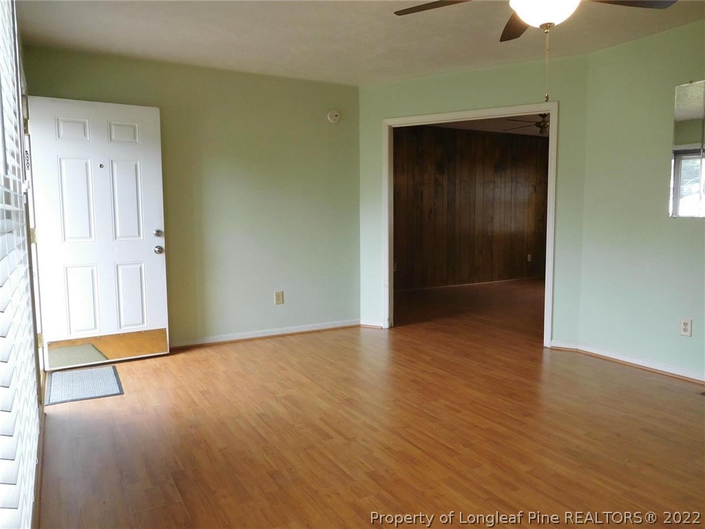 419 Saddle Ridge Road Fayetteville, NC 28311 - Photo 3 of 21 an empty room with wooden floor closet and windows