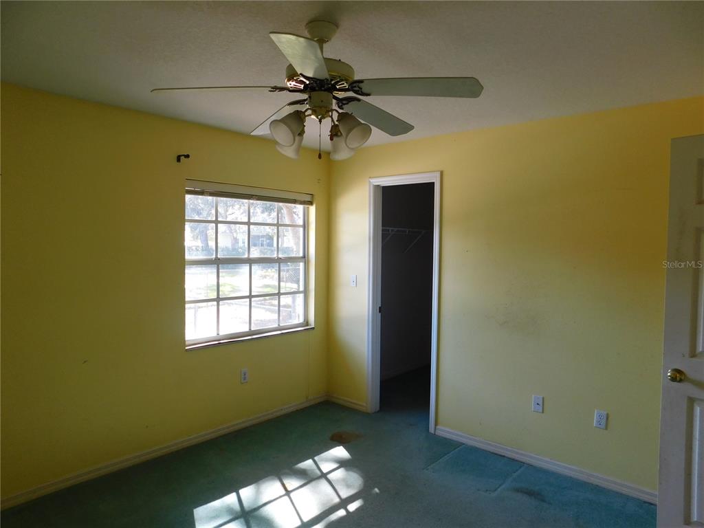 5821 Buck Run Drive Lakeland, FL 33811 - Photo 13 of 30 an empty room with a ceiling fan and a window