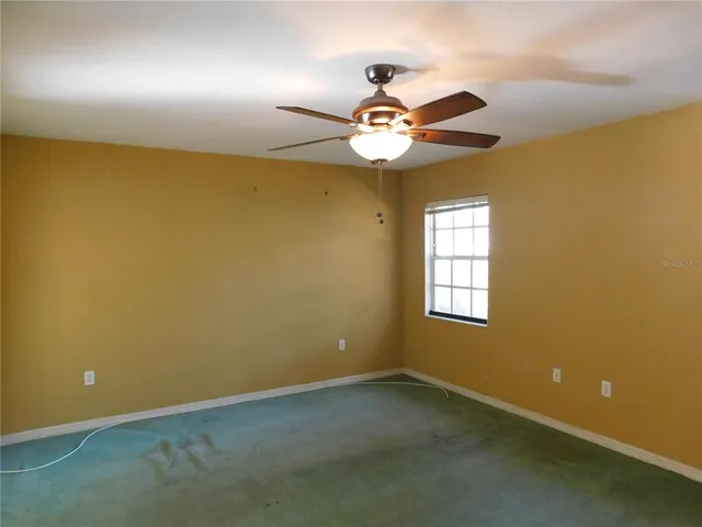 a very nice looking room with a ceiling fan