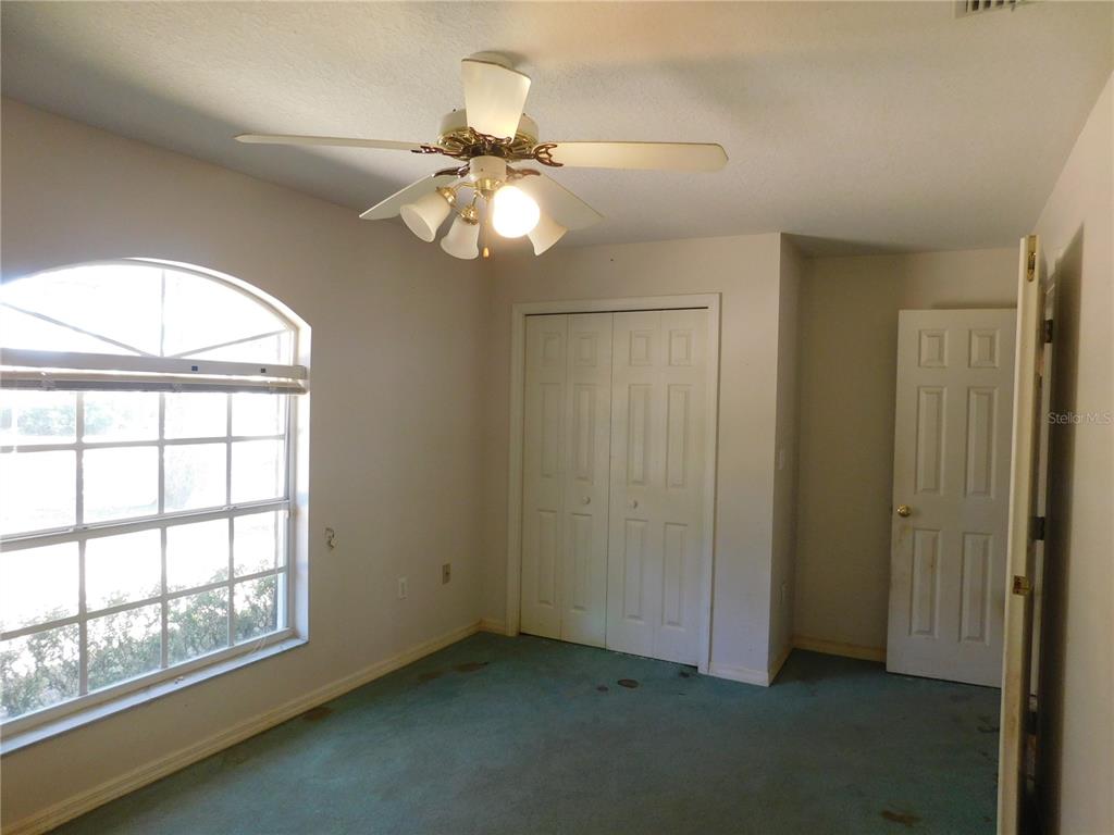 5821 Buck Run Drive Lakeland, FL 33811 - Photo 16 of 30 an empty room with windows and fan