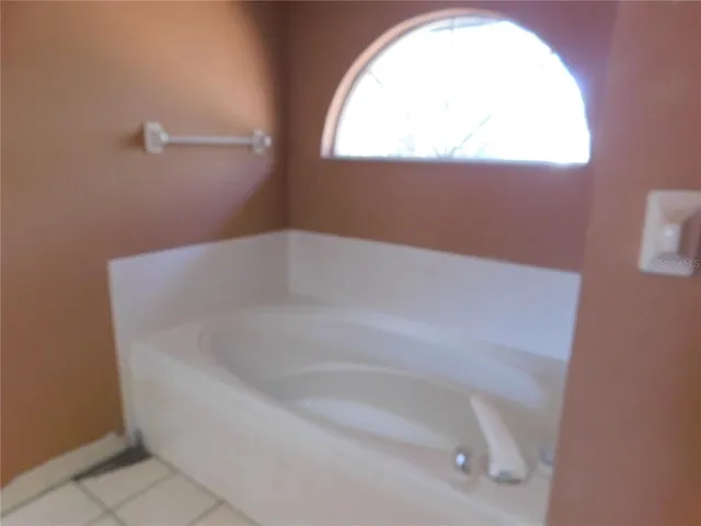 a white bath tub sitting next to a window