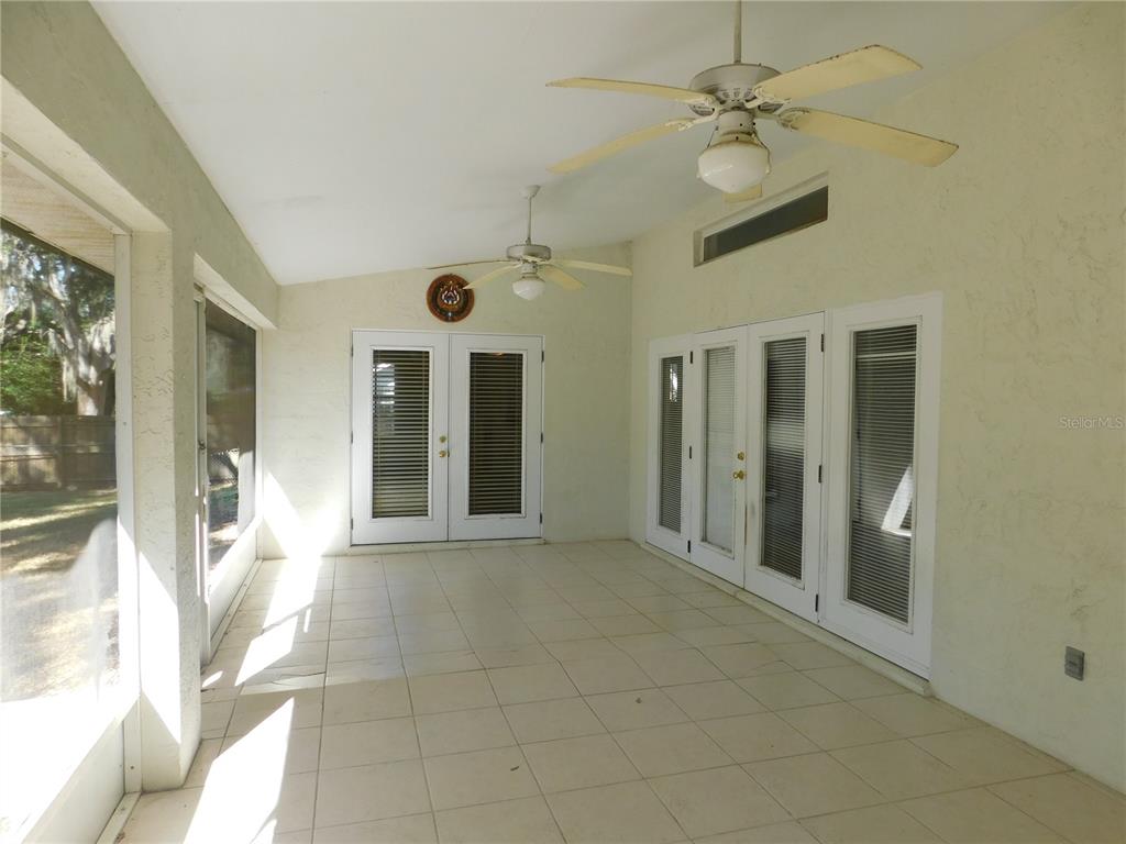 5821 Buck Run Drive Lakeland, FL 33811 - Photo 25 of 30 a view of a big room with a chandelier fan and windows
