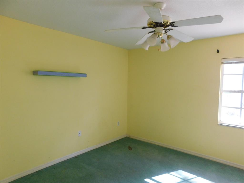 5821 Buck Run Drive Lakeland, FL 33811 - Photo 10 of 30 an empty room with a window and a ceiling fan