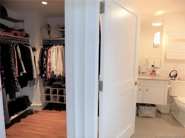 a view of walk in closet with clothes and shoes