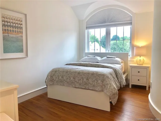 a bed sitting in a bedroom next to a window