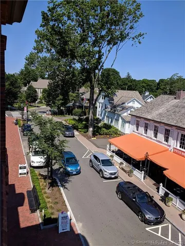 an aerial view of a houses with swimming pool and outdoor seating