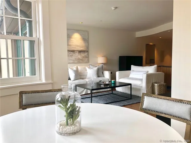 a living room with furniture flowerpot and a window