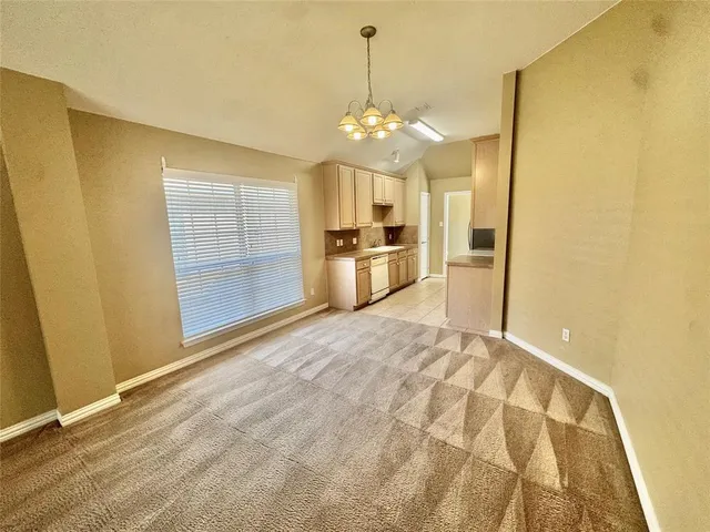 a view of a kitchen with a sink and dishwasher cabinets