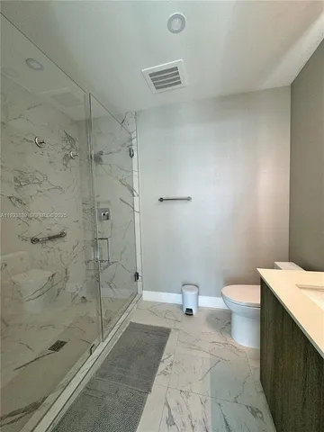 a bathroom with a toilet and shower