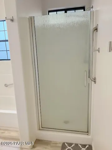 a bathroom with a glass shower door