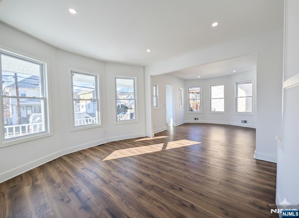 93 May Street Hawthorne, NJ 07506 - Photo 6 of 21 a view of an empty room with wooden floor and a window