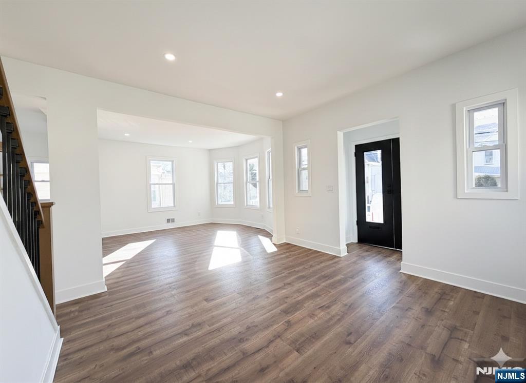 93 May Street Hawthorne, NJ 07506 - Photo 7 of 21 an empty room with wooden floor and windows