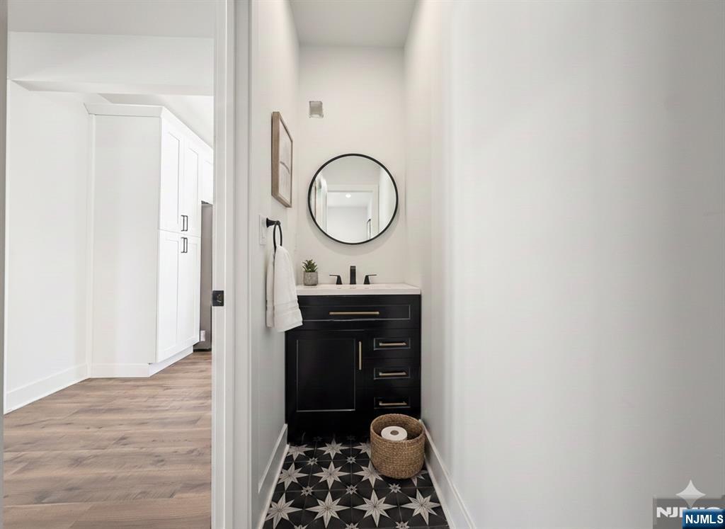 93 May Street Hawthorne, NJ 07506 - Photo 9 of 21 a bathroom with a sink and a mirror