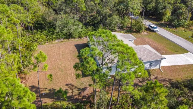 an aerial view of a house with a yard