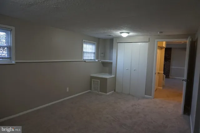 a view of empty room with window and fireplace