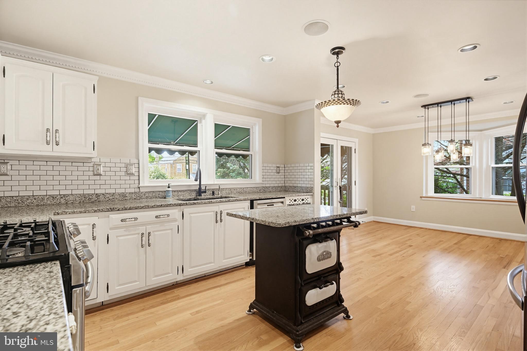 8111 Barksdale Road Baltimore, MD 21286 - Photo 11 of 39 a kitchen with granite countertop sink stove and wooden floor