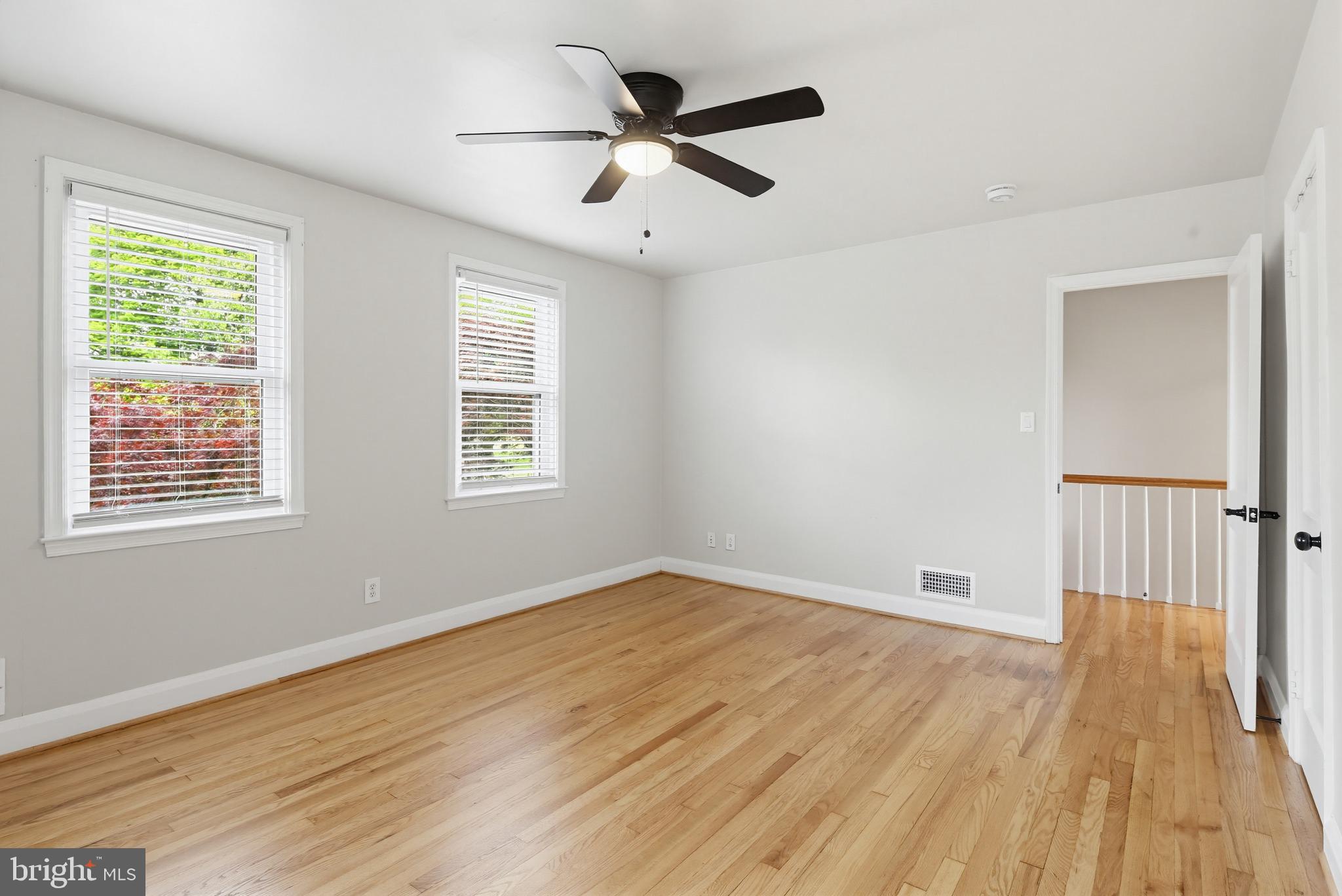 8111 Barksdale Road Baltimore, MD 21286 - Photo 13 of 39 a view of an empty room with wooden floor and a window
