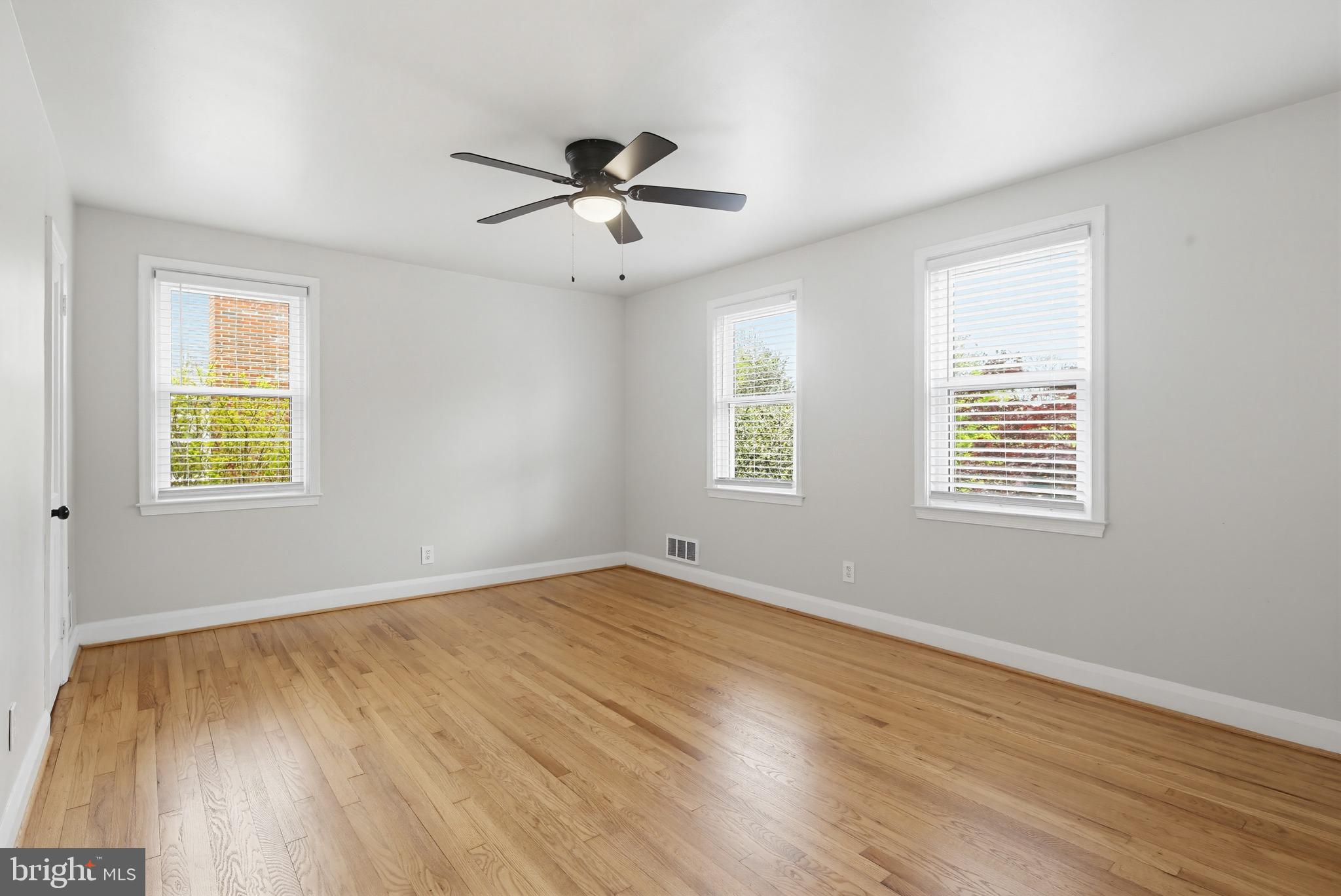 8111 Barksdale Road Baltimore, MD 21286 - Photo 14 of 39 a view of an empty room with wooden floor and a window