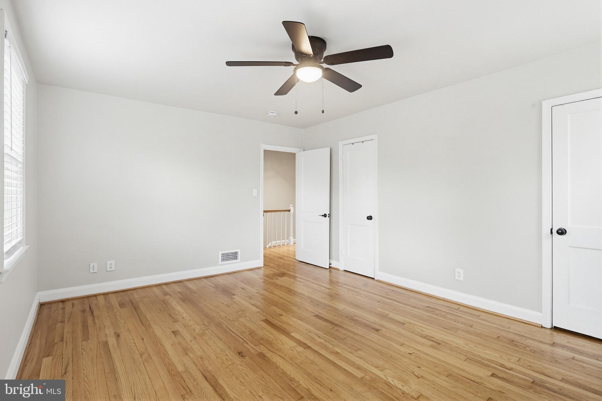 8111 Barksdale Road Baltimore, MD 21286 - Photo 15 of 39 an empty room with wooden floor and windows