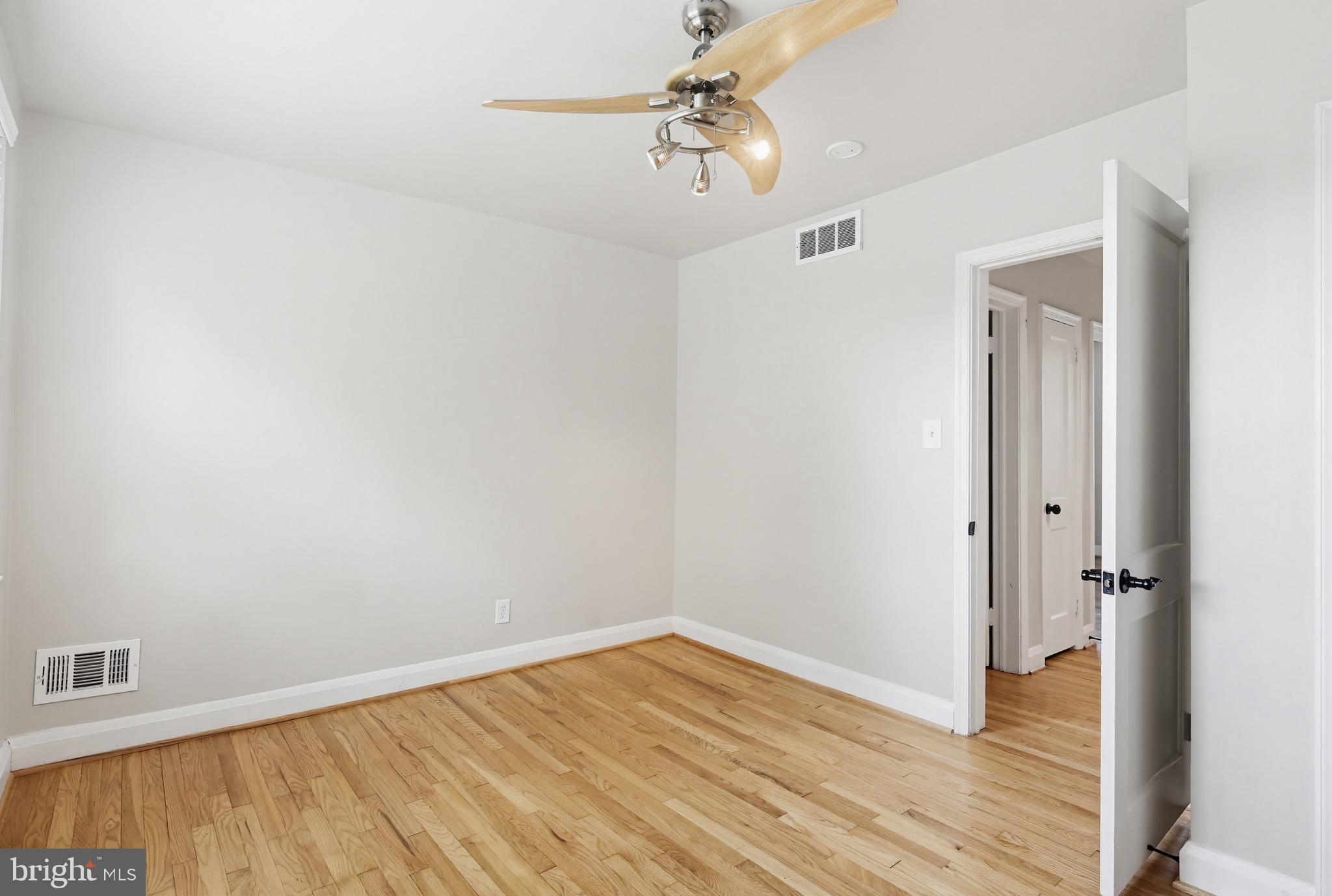 8111 Barksdale Road Baltimore, MD 21286 - Photo 18 of 39 wooden floor in an empty room