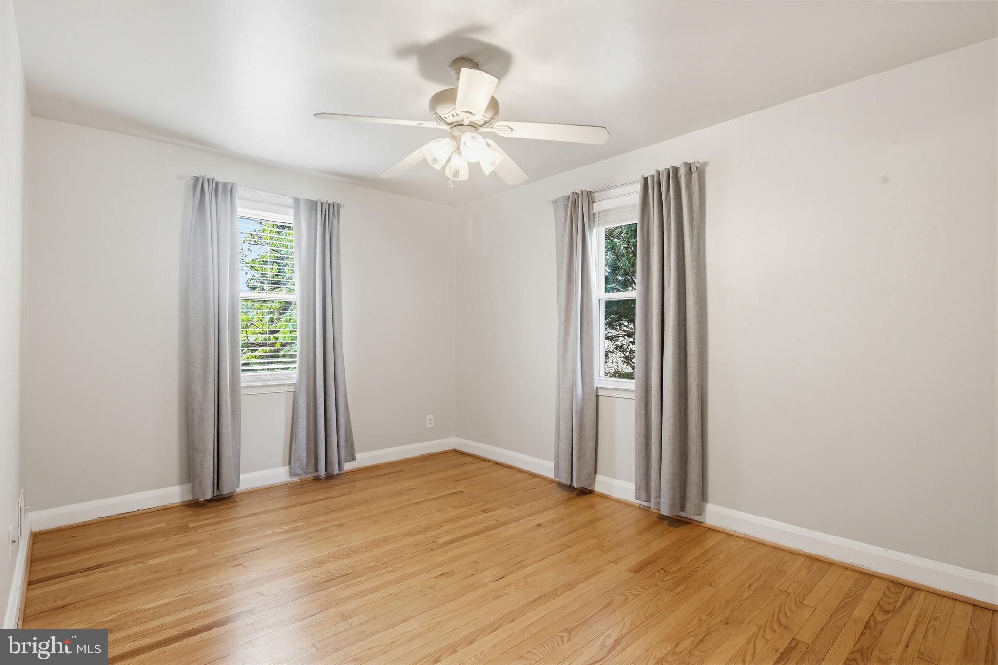 8111 Barksdale Road Baltimore, MD 21286 - Photo 20 of 39 a view of an empty room with wooden floor and a window