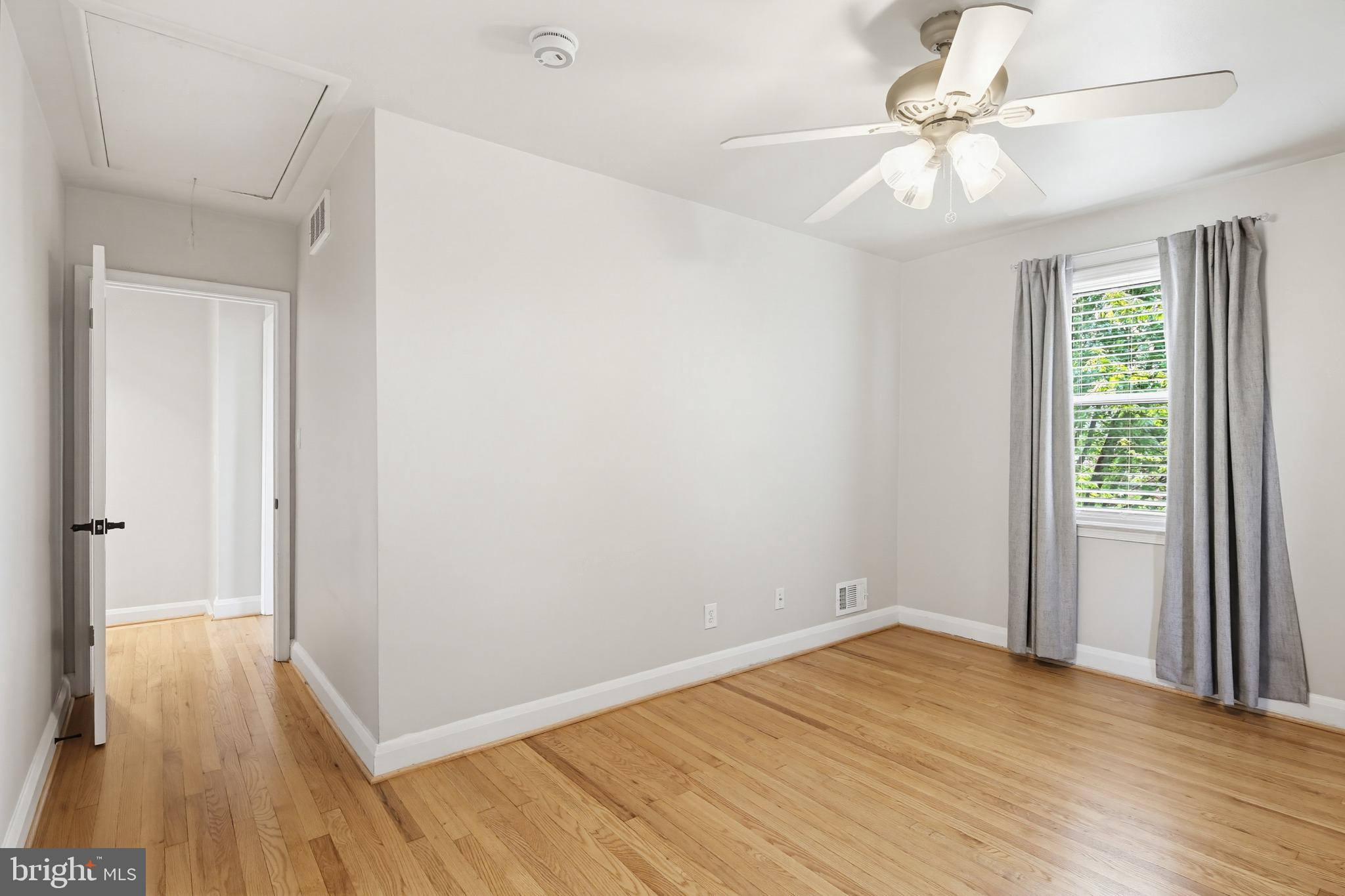 8111 Barksdale Road Baltimore, MD 21286 - Photo 21 of 39 wooden floor in an empty room with a window