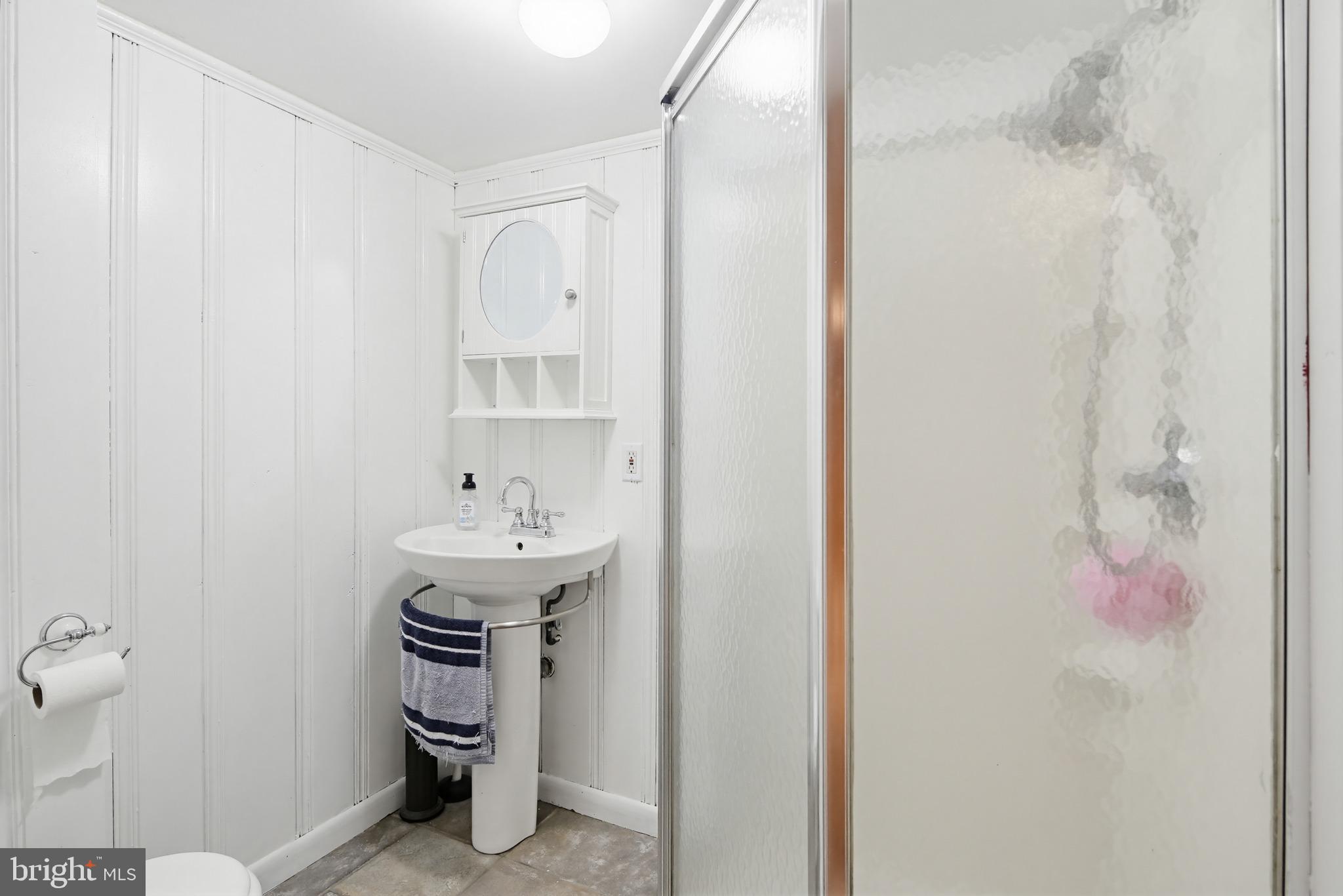 8111 Barksdale Road Baltimore, MD 21286 - Photo 26 of 39 a bathroom with a sink and a mirror