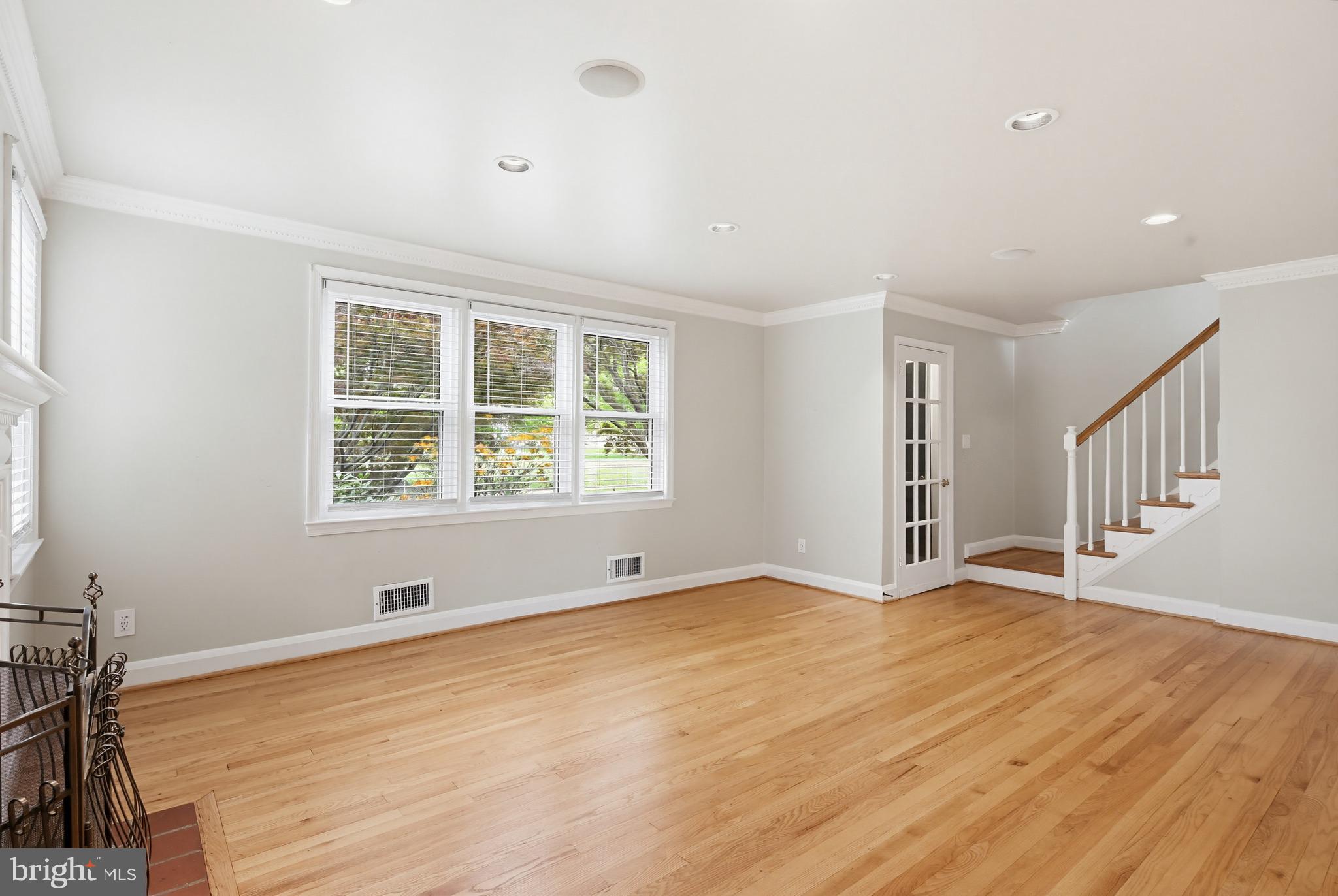 8111 Barksdale Road Baltimore, MD 21286 - Photo 5 of 39 a view of an empty room with wooden floor and a window