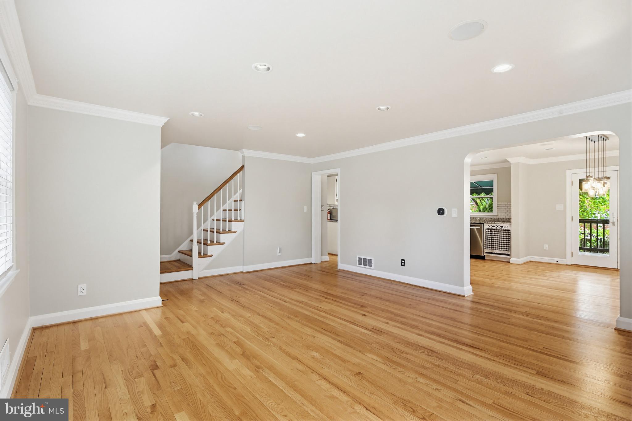 8111 Barksdale Road Baltimore, MD 21286 - Photo 6 of 39 a view of an empty room with wooden floor and stairs