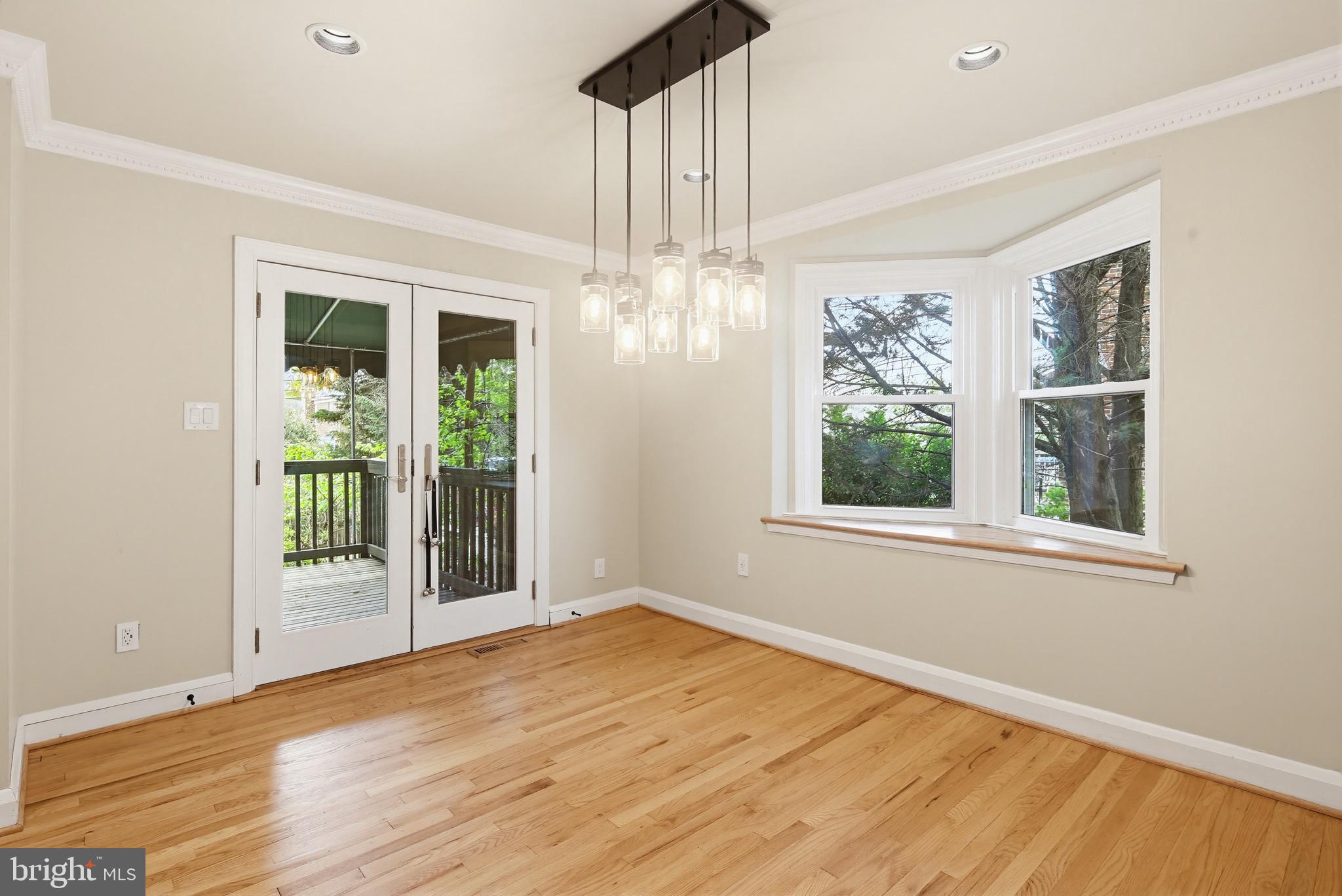 8111 Barksdale Road Baltimore, MD 21286 - Photo 8 of 39 a view of an empty room with wooden floor and a window