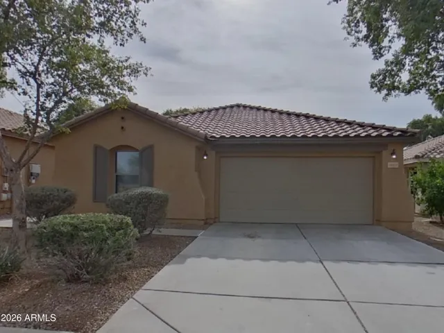 a front view of a house with plants