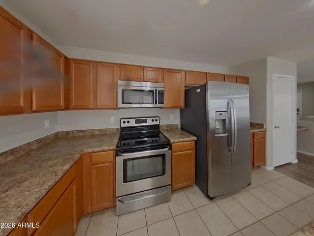 a kitchen with a stove microwave and refrigerator