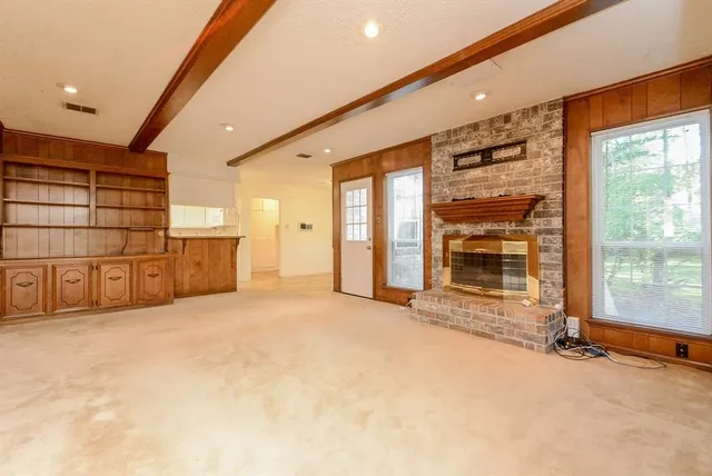 a view of an empty room with a fireplace