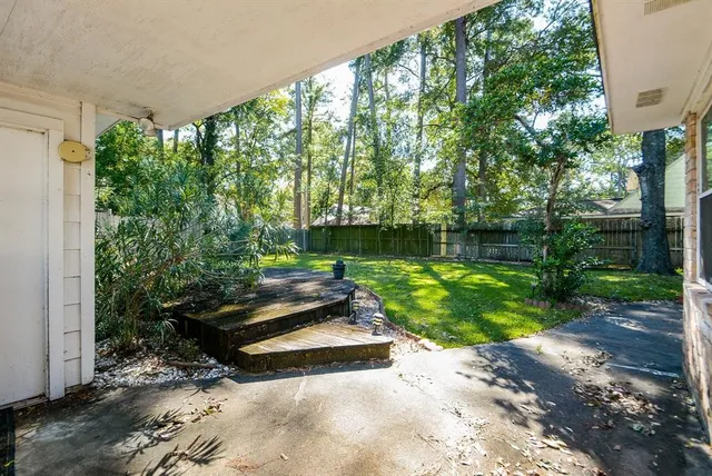a view of a house with a big yard and large trees
