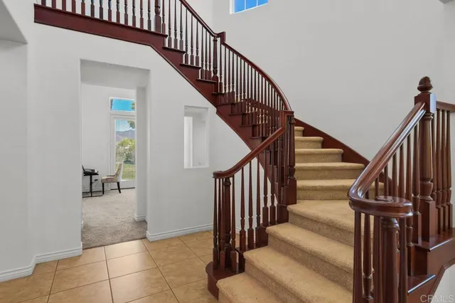 a living room with furniture potted plant and a large window