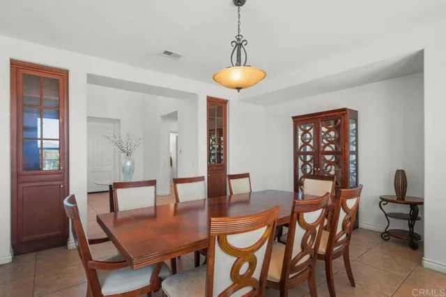 a kitchen with a table chairs sink and cabinets