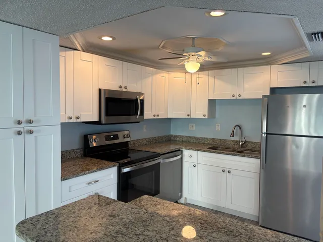 a kitchen with a sink stove and refrigerator