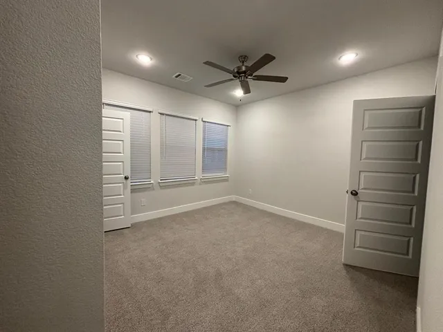 a view of an empty room and a window