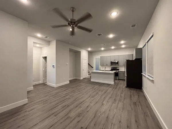 a view of kitchen with refrigerator microwave and wooden floor