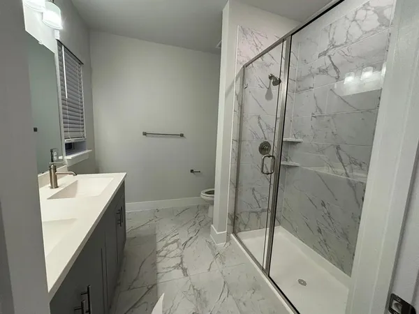 a bathroom with a shower and a sink