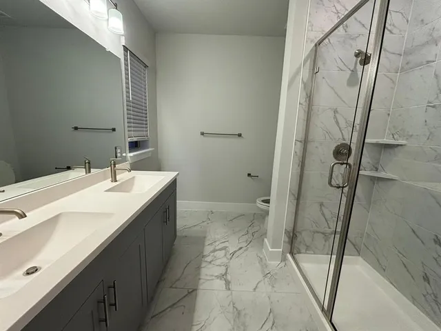 a bathroom with a double vanity sink and mirror
