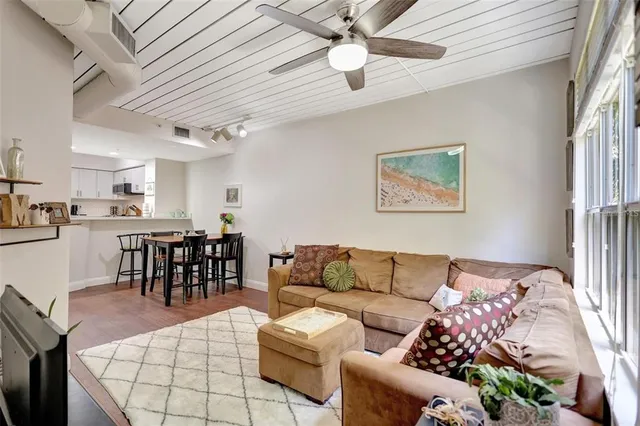 a living room with furniture kitchen view and a dining table