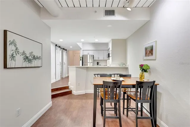 a view of a dining room with furniture and wooden floor