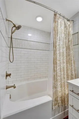 a bathroom with a shower and a bath tub