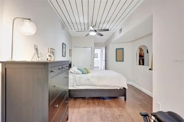 a spacious bedroom with a bed and a chandelier